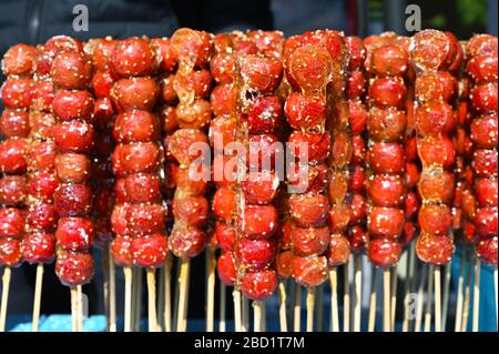Tanghulu, skewered sugar-glazed berries sold in the outdoor market places or from street carts, Beijing, China, Asia Stock Photo