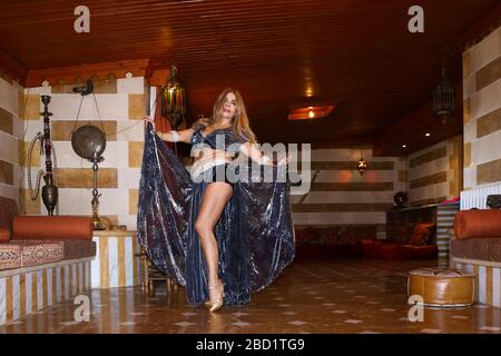 Beirut, Lebanon - May 30, 2017: Graceful mature woman of Lebanese origin performing traditional belly dance in the indoors. Stock Photo