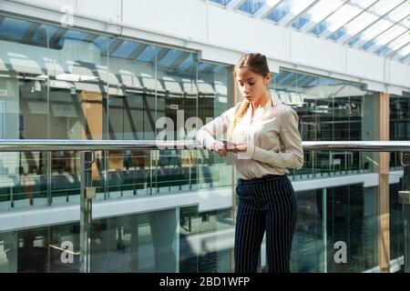 Portrait of a businesswoman are standing on the background of glass offices. Stock Photo