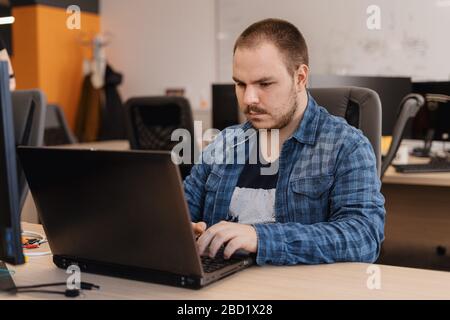Authentic programmer working on desktop pc programming code technologies or website design at office Software Development Company Stock Photo