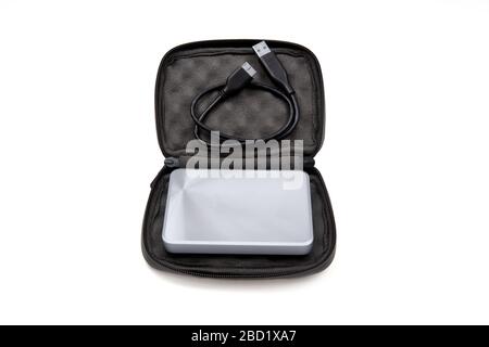 External hard disk drive and usb cable in a carrying case isolated on white. Black pouch for portable HDD. Stock Photo
