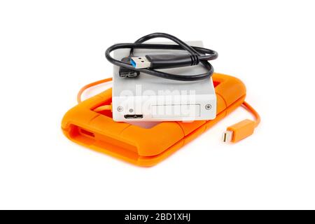 Padded orange hard disk drive. Silver HDD on top of its protection housing. Stock Photo