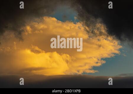 Dramatic clouds illuminated rising of sun floating blue sky. Natural weather, meteorology background. Heavenly landscape image ready for design Stock Photo