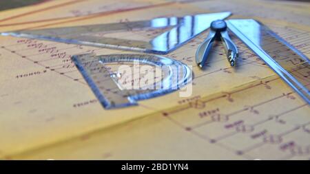 Electrical engineer workplace - electrotechnical project, rulers, and divider compass. Construction concept. Engineering tools. Stock Photo