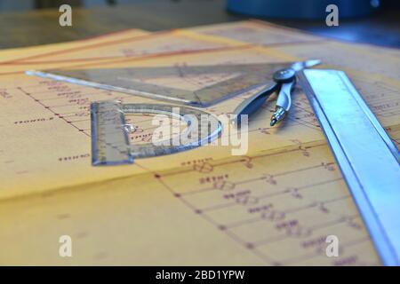 Electrical engineer workplace - electrotechnical project, rulers, and divider compass. Construction and electrotechnology concept. Engineering tools Stock Photo