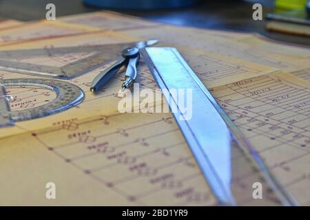 Electrical engineer workplace - electrotechnical project, rulers, and divider compass. Construction and electrotechnology concept. Engineering tools Stock Photo