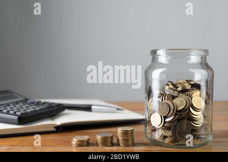 Coins In A Jar And Stacks Of Change With Savings Notepad And Calculator In A Background Money Collecting Or Accounting Abstract Concept Copy Space Stock Photo Alamy