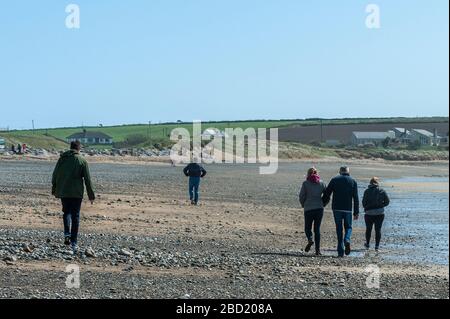 Garrettstown, West Cork, Ireland. 6th Apr, 2020. People were on the beach at Garrettstown today and most were observing the Government's social distancing guidelines issued due to the Covid-19 pandemic. Credit: Andy Gibson/Alamy Live News Stock Photo