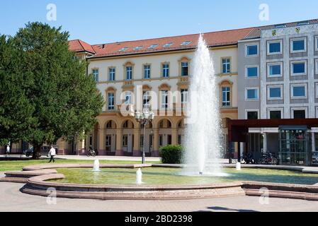 Karlsruhe, Germany - July 27, 2018. Urban landscape with facade of Natural History Museum and fountain before building on a background of clear blue s Stock Photo