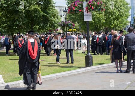 University students gathering outside Bristol Cathedral prior to their graduation ceremony Stock Photo