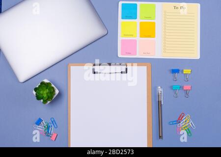 Top view of Blank To do list for the week, pen, stationery and laptop on light purple background, flat lay. Copy space. Free space. Schedule Stock Photo