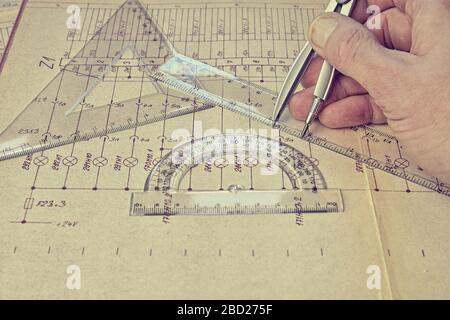 Electrical engineer workplace - electrotechnical project, rulers, and divider compass. Construction and electrotechnology concept. Engineering tools Stock Photo