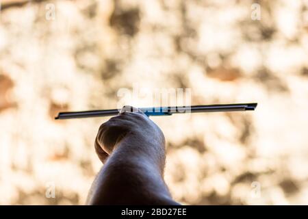 Man cleaning window using window cleaning squeegee and cleaning sprayer, cleaning services concept. Housework and housekeeping concept Stock Photo