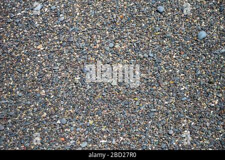 Black pebbles on a stone beach Stock Photo