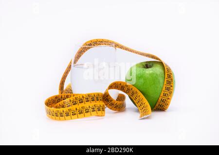 yellow tape measure and a green apple Stock Photo