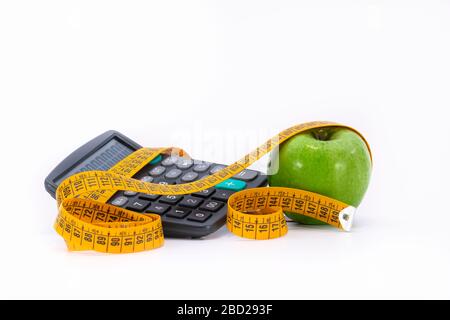 calculator with yellow tape measure and a green apple Stock Photo