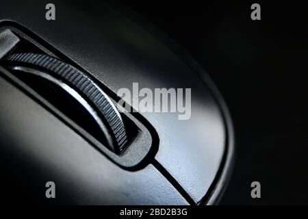 Macro of black mouse on black desk Stock Photo