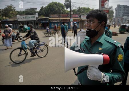 March 26, 2020 Sylhet, Bangladesh: Sylhet Metropolitan Police  rising awarness and providing sanitizer among to mass people as a precautionary measure against the spread of the COVID-19 in the street of Sylhet, Bangladesh. Stock Photo