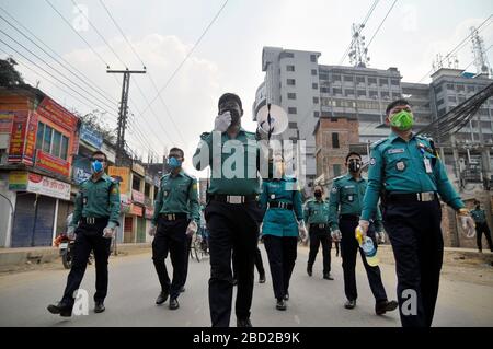 March 26, 2020 Sylhet, Bangladesh: Sylhet Metropolitan Police  rising awarness and providing sanitizer among to mass people as a precautionary measure against the spread of the COVID-19 in the street of Sylhet, Bangladesh. Stock Photo