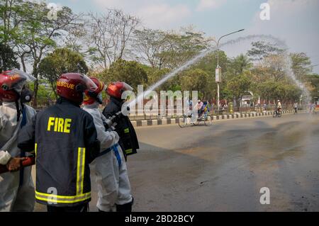 March 26, 2020, Sylhet, Bangladesh: Bangladeshi Firefighters sprays disinfectant at street of Sylhet city  amid concerns about the spread of coronavirus disease (COVID-19) in  Bangladesh Stock Photo