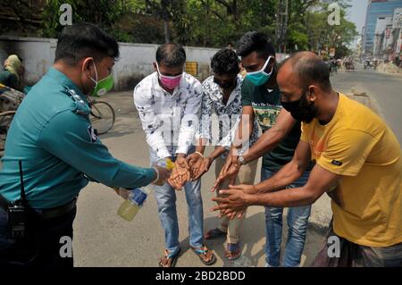 March 26, 2020 Sylhet, Bangladesh: Sylhet Metropolitan Police  rising awarness and providing sanitizer among to mass people as a precautionary measure against the spread of the COVID-19 in the street of Sylhet, Bangladesh. Stock Photo