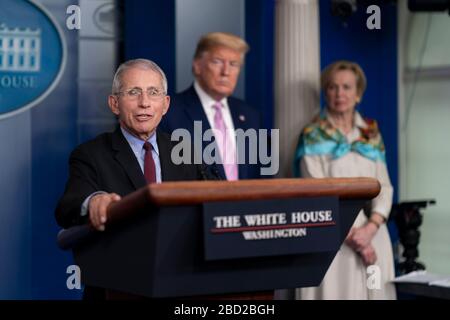 Dr. Anthony Fauci, Director of the National Institute of Allergy and Infectious Diseases, responds to a question from reporters during the daily COVID-19, coronavirus briefing in the Press Briefing Room of the White House April 4, 2020 in Washington, DC. Standing left to right are: Dr. Anthony Fauci, President Donald Trump and Amb. Deborah Birx, Task Force Director. Stock Photo