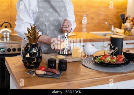 Housewife preparing salad in the kitchen. Cooking at home concept. Stock Photo