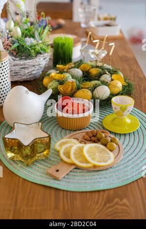 Dyed Easter eggs with snacks. Easter table decorations. Stock Photo