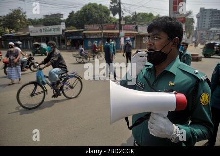 March 26, 2020 Sylhet, Bangladesh: Sylhet Metropolitan Police  rising awarness and providing sanitizer among to mass people as a precautionary measure against the spread of the COVID-19 in the street of Sylhet, Bangladesh. Stock Photo