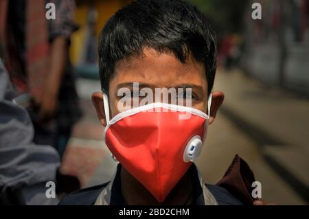 March 26, 2020, Sylhet, Bangladesh- A littleboy wearing mask in the street of Sylhet, Bangladesh as a preventive measure against the spread of the COVID-19 corona virus Stock Photo