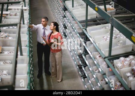 Businesspeople counting stock in a store room Stock Photo