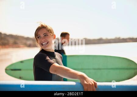 Portrait of young female surfer at the beach. Stock Photo