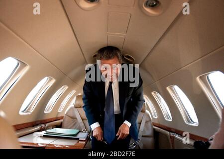 Businessman standing in a private jet and smiling Stock Photo