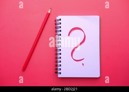 The text WHY on white paper on red background . Stock Photo