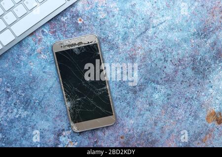 top view of broken smart phone on table . Stock Photo