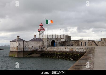 National Flag of Ireland flying at Dun Laoghaire Lighthouse in County Dublin Stock Photo