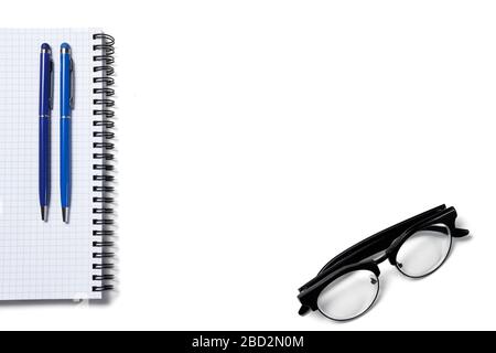 white office table with notepad, glasses, calculator and other supplies. Top view, flat lay. Work from home. Study from home Stock Photo