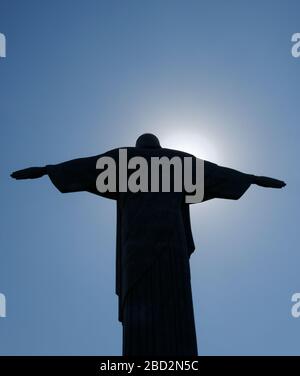 Silhouette Of Jesus Christ With Outstretched Arms On Color Background 