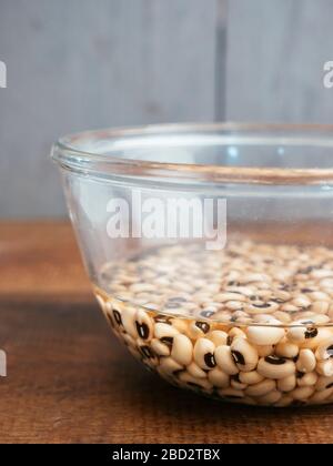 Dried black-eyed peas soaking in water Stock Photo
