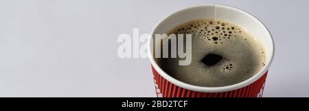Take-out coffee in opened thermo cup against white. Stock Photo