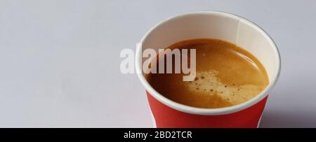 Take-out coffee in opened thermo cup against white. Stock Photo