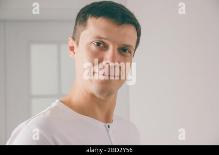 Young attractive man portrait in white T-shirt Stock Photo