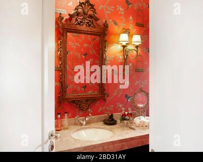 Home interior, classic bathroom. Wall lined red paper. Stock Photo
