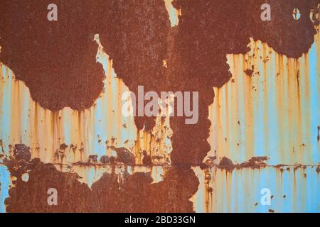Multicolored background, rusty metal surface with blue paint flaking and cracking texture Stock Photo