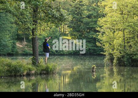 Young Man Taking Photos Of Landscape With Mobile Smart Phone Stock Photo
