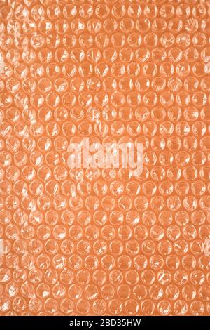 Air bubble packaging on a brown background. Not environmentally friendly plastic material. Environmental damage concept. Stock Photo