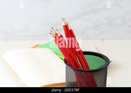 Pencils in black metal pen on colored cards. Concept back to school. Stock Photo