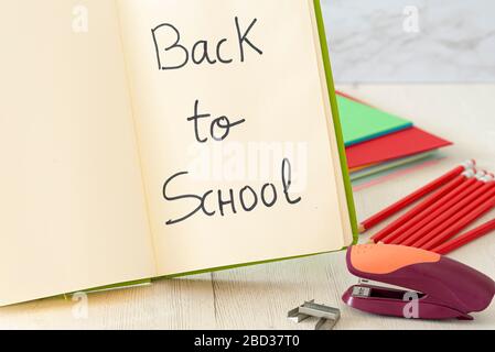 Notepad and stapler on wooden table. Concept back to school. Stock Photo