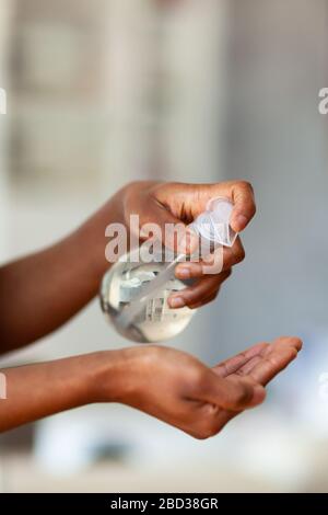 Black African American woman hand using antibacterial antiseptic hand sanitizer gel Stock Photo