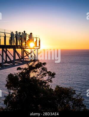 Tourists enjoy the sunset over the Pacific Ocean from the lighthouse lookout in Mazatlan, Sinaloa, Mexico. Stock Photo
